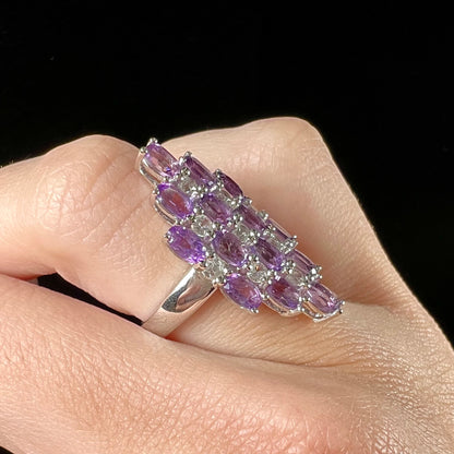 A ladies' modern style sterling silver amethyst and cubic zirconia cluster ring.