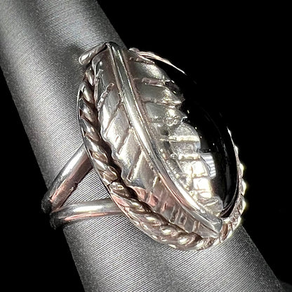 A sterling silver unisex black onyx feather ring.