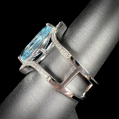 A ladies' marquise cut blue topaz and cubic zirconia accented ring cast in sterling silver.