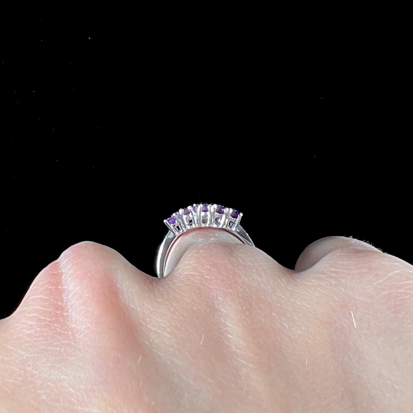 A ladies' modern style sterling silver amethyst and cubic zirconia cluster ring.