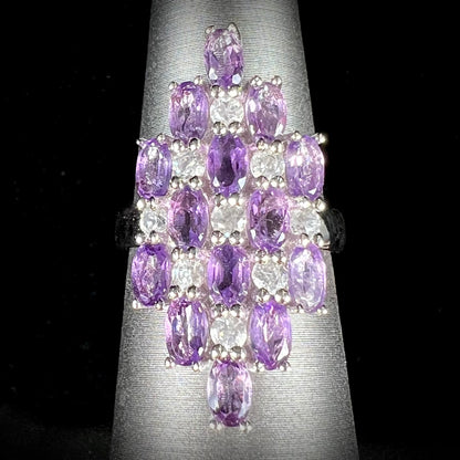 A ladies' modern style sterling silver amethyst and cubic zirconia cluster ring.