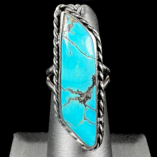 A vintage, Southwest style sterling silver ring set with a natural turquoise stone.  The stone is blue with a black matrix.