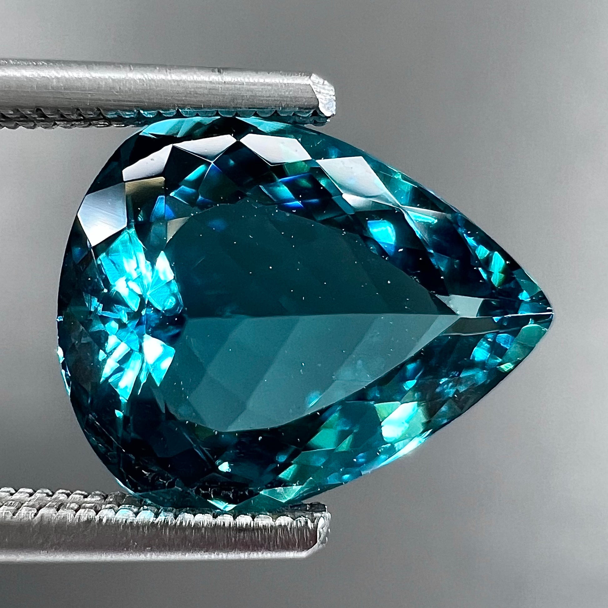A loose, pear shaped green-blue indicolite tourmaline stone.