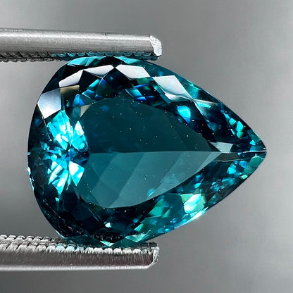 A loose, pear shaped green-blue indicolite tourmaline stone.