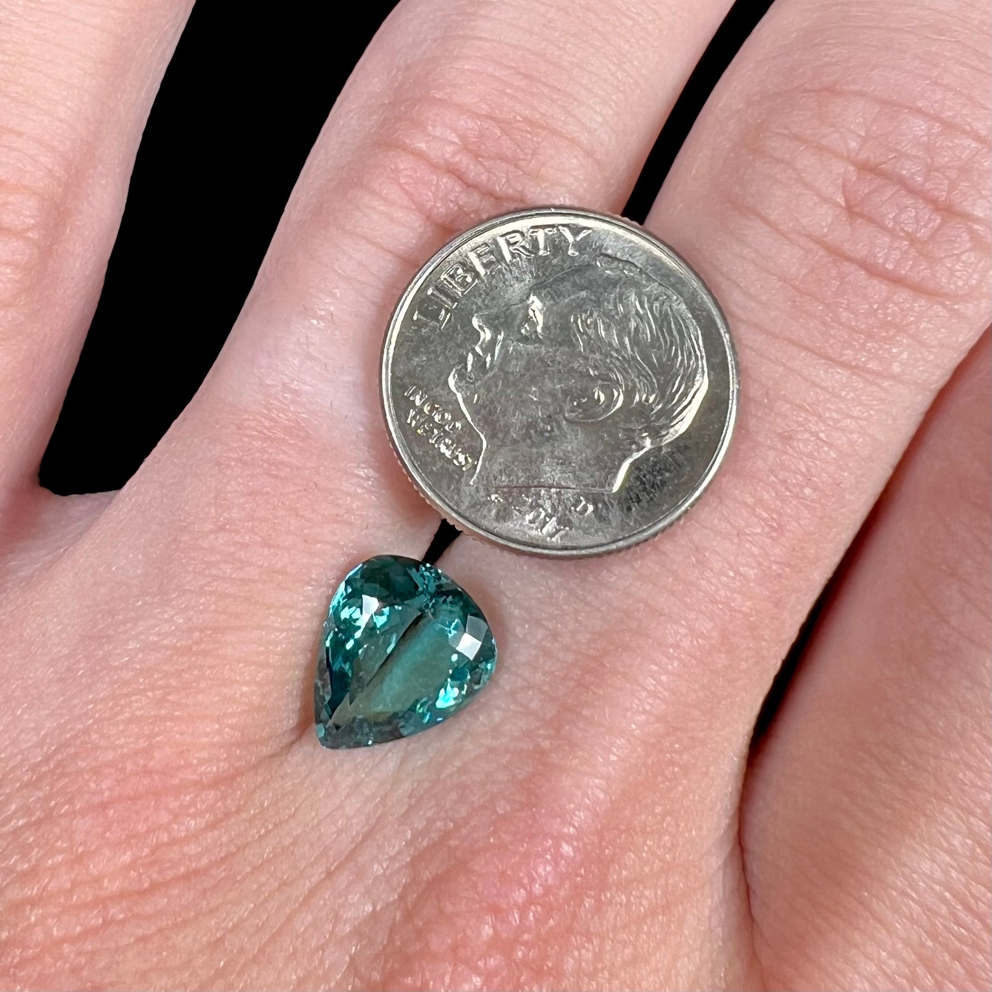 A loose, pear shaped green-blue indicolite tourmaline stone.