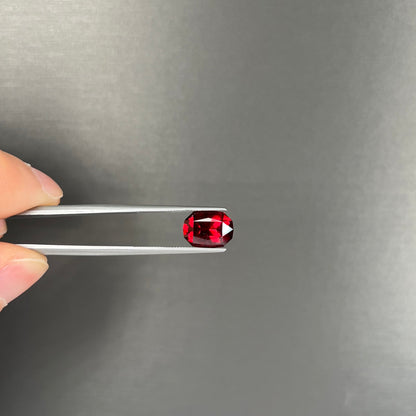 A loose, octagon cut rhodolite garnet gemstone.  The stone is a deep, purplish crimson red color.