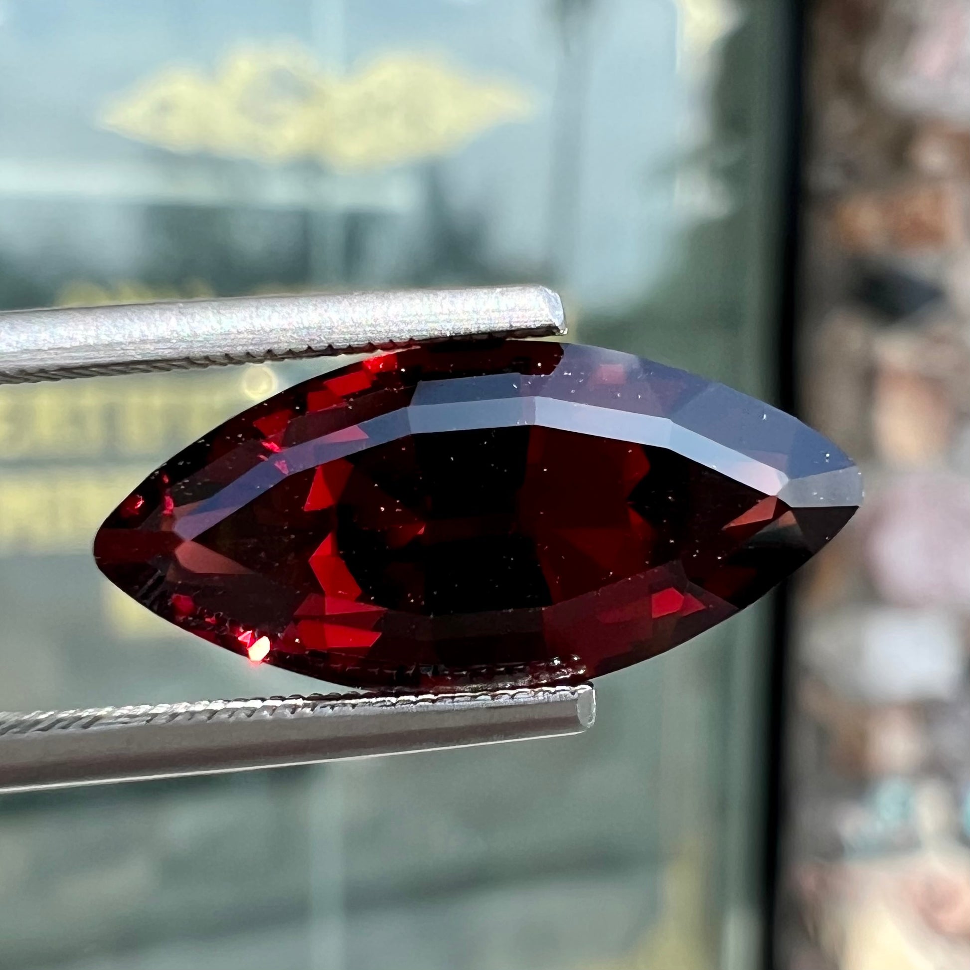 A faceted marquise cut red pyrope garnet stone.