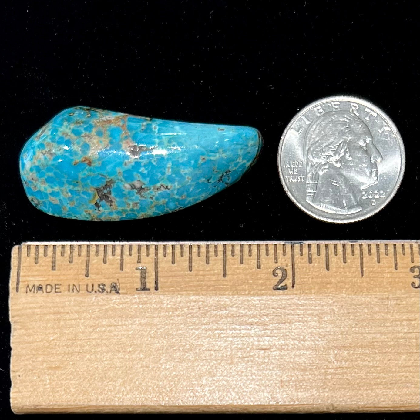A loose, freeform cabochon cut Kingman turquoise stone from Arizona.  The stone is blue with gray and brown matrix.
