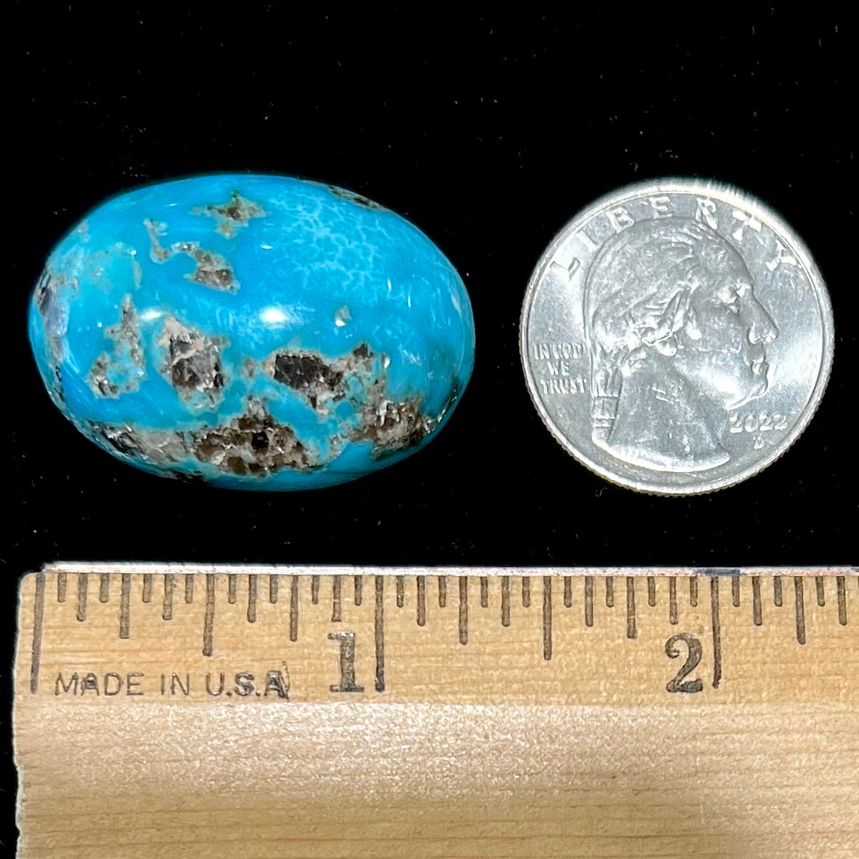 A loose, oval cabochon cut turquoise stone from Kingman, Arizona.