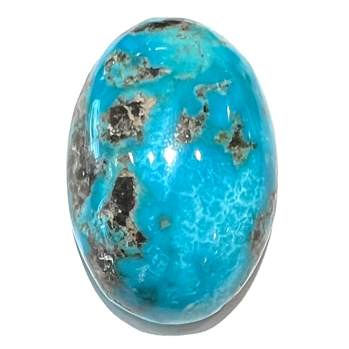 A loose, oval cabochon cut turquoise stone from Kingman, Arizona.