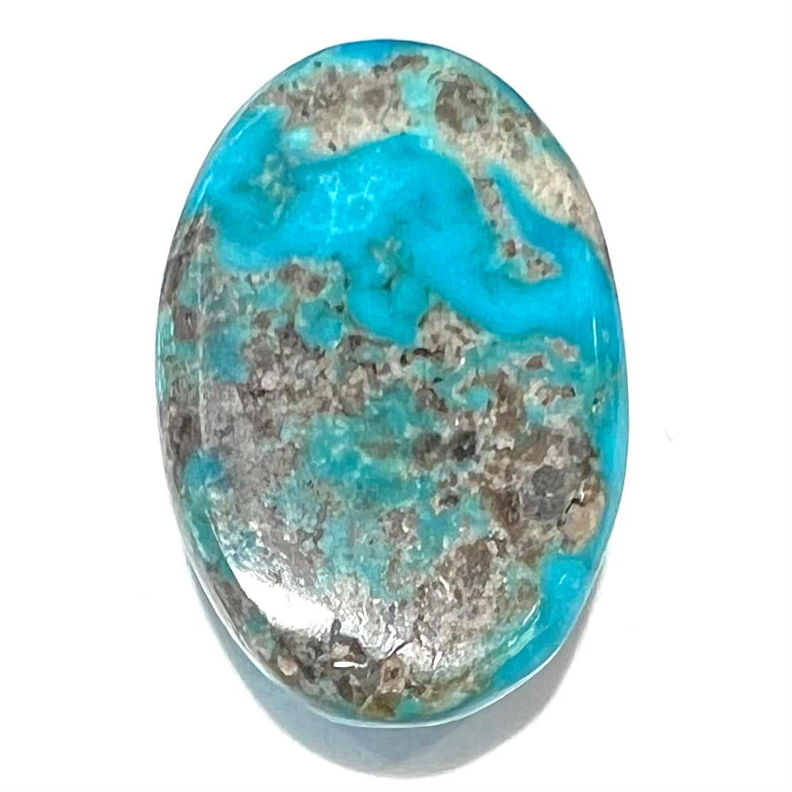 A loose, oval cabochon cut turquoise stone from Kingman, Arizona.