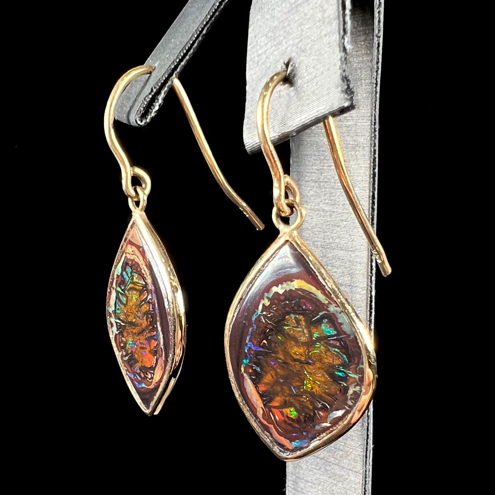 A pair of yellow gold dangle earrings bezel set with natural boulder opals from Koroit, Australia.