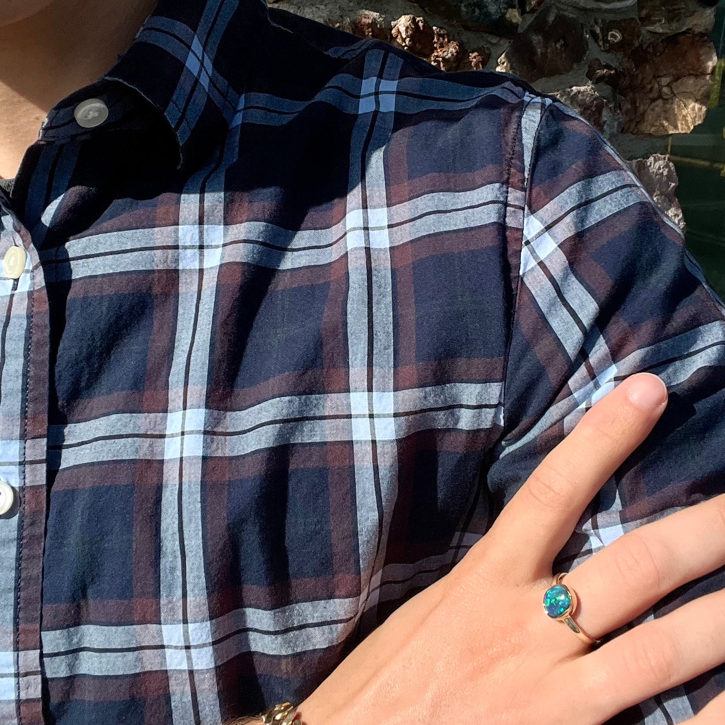 A ladies' natural black crystal opal solitaire ring handmade in 14 karat yellow gold.