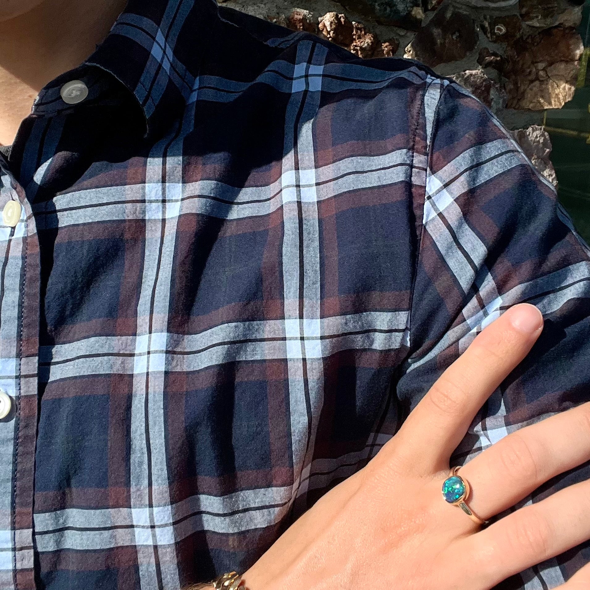 A ladies' natural black crystal opal solitaire ring handmade in 14 karat yellow gold.