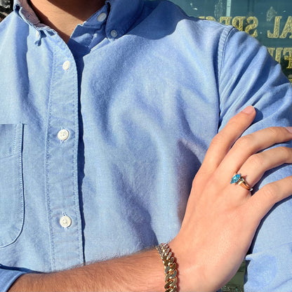 A ladies' estate yellow gold ring, prong set with a marquise cut blue topaz stone.  There are scratches on the shank.