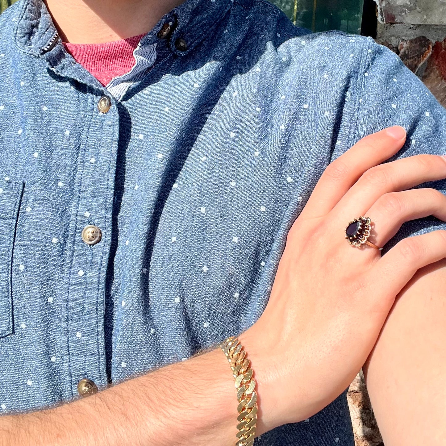 A vintage, 1940's style yellow gold ring set with a pear shaped almandine garnet.  A halo of round garnets surround the center stone.