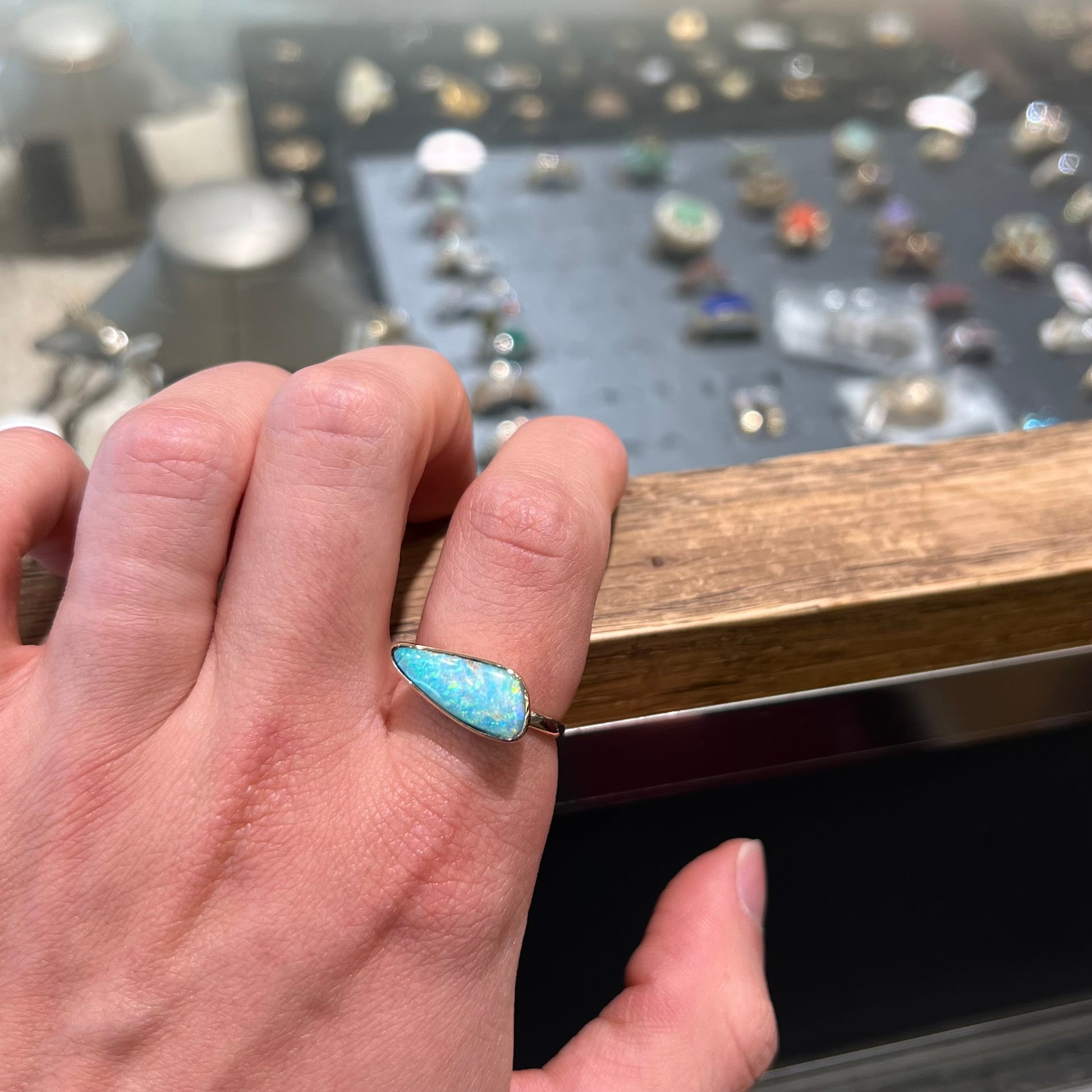 A ladies yellow gold solitaire ring bezel set with a natural opalized seashell from Coober Pedy, Australia.