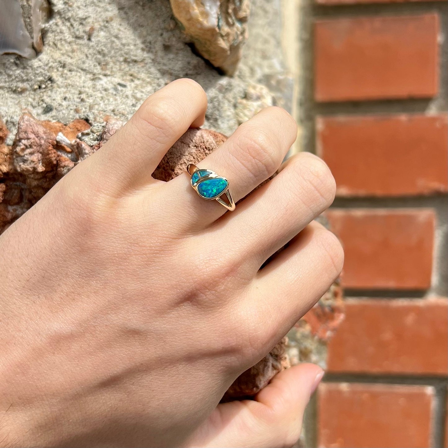 A ladies' black opal inlay ring cast in yellow gold.