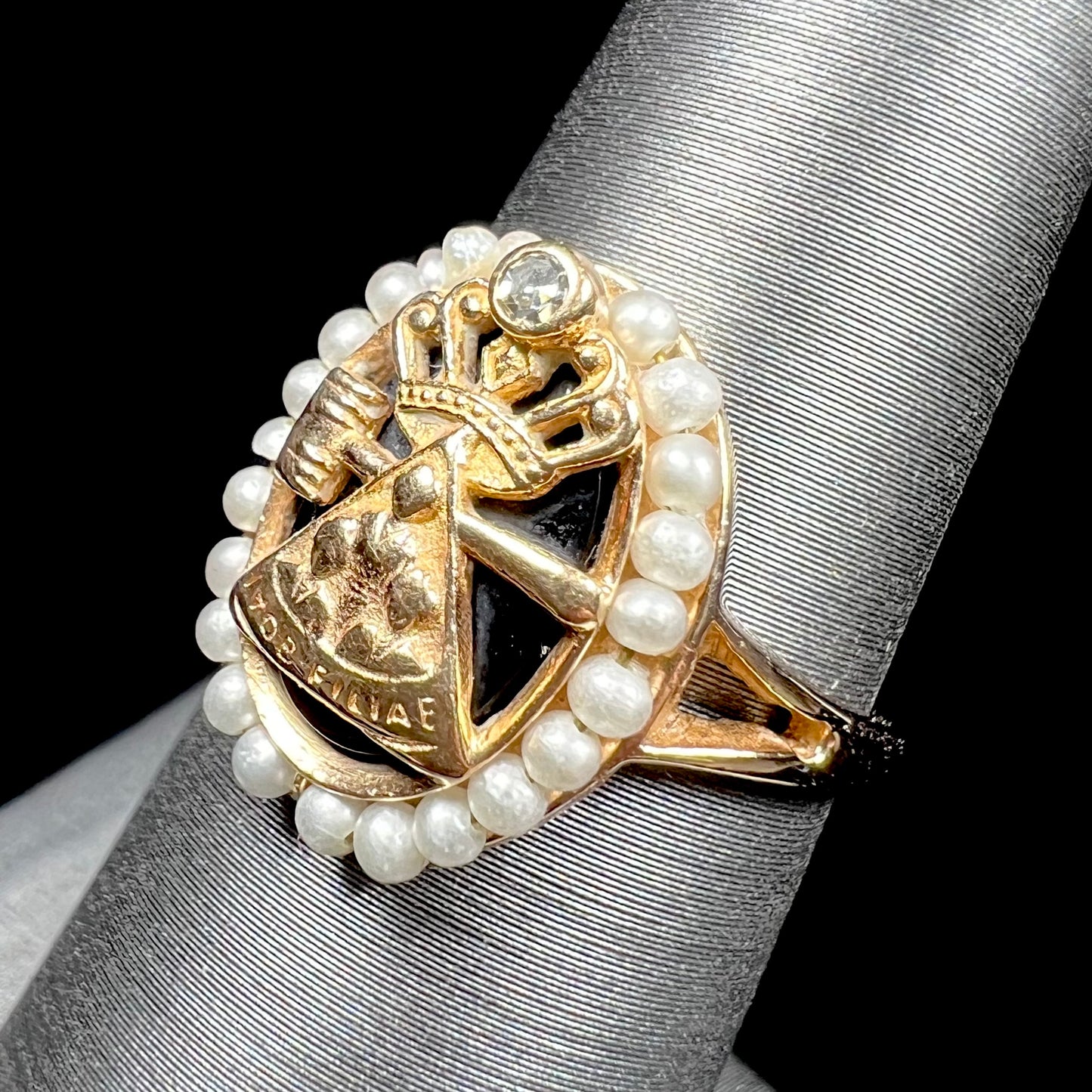 A ladies' Job's Daughters youth organization ring cast in 14 karat gold, set with a diamond and string of pearls.