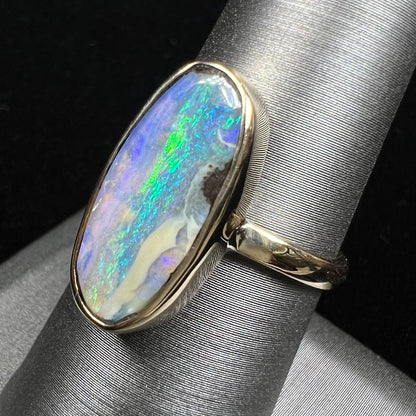 Ladies' yellow gold solitaire ring bezel set with a natural green striped boulder opal from Quilpie, Australia.
