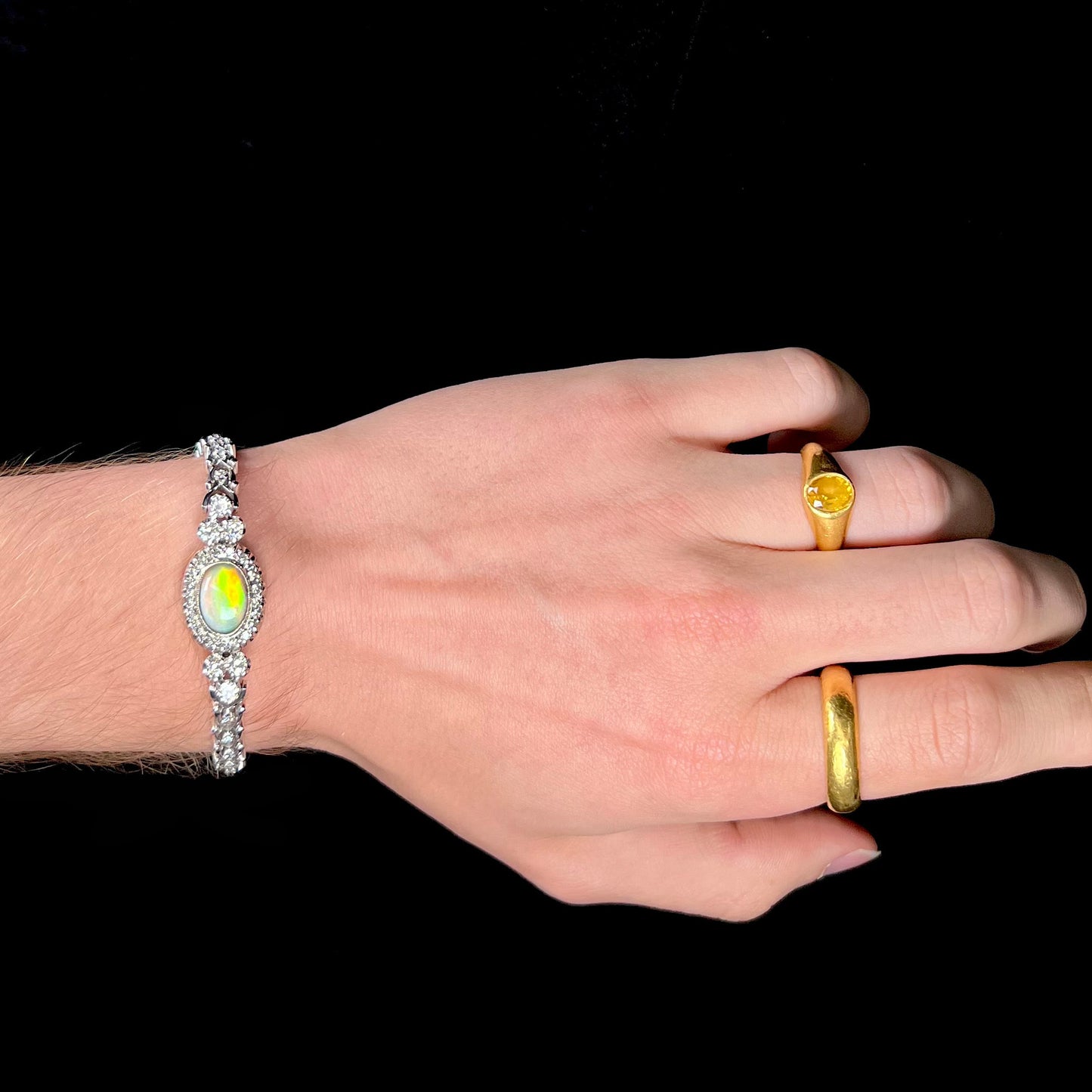 A ladies' vintage, 1930's natural opal bracelet set with accent diamonds in white gold.