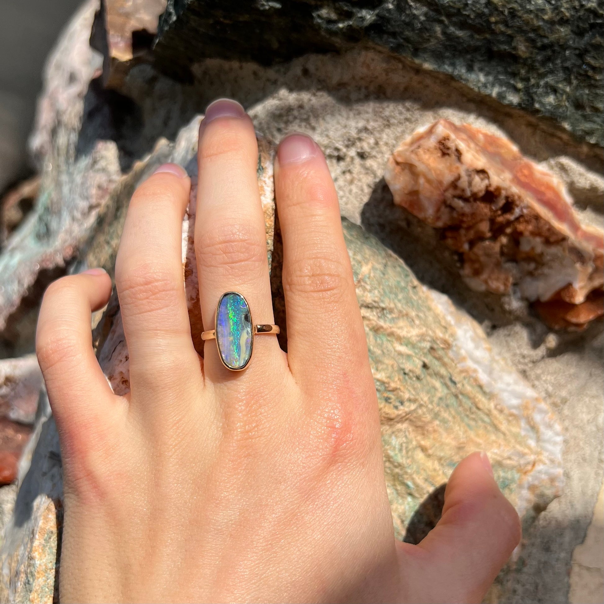 Ladies' yellow gold solitaire ring bezel set with a natural green striped boulder opal from Quilpie, Australia.