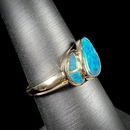 A ladies' black opal inlay ring cast in yellow gold.