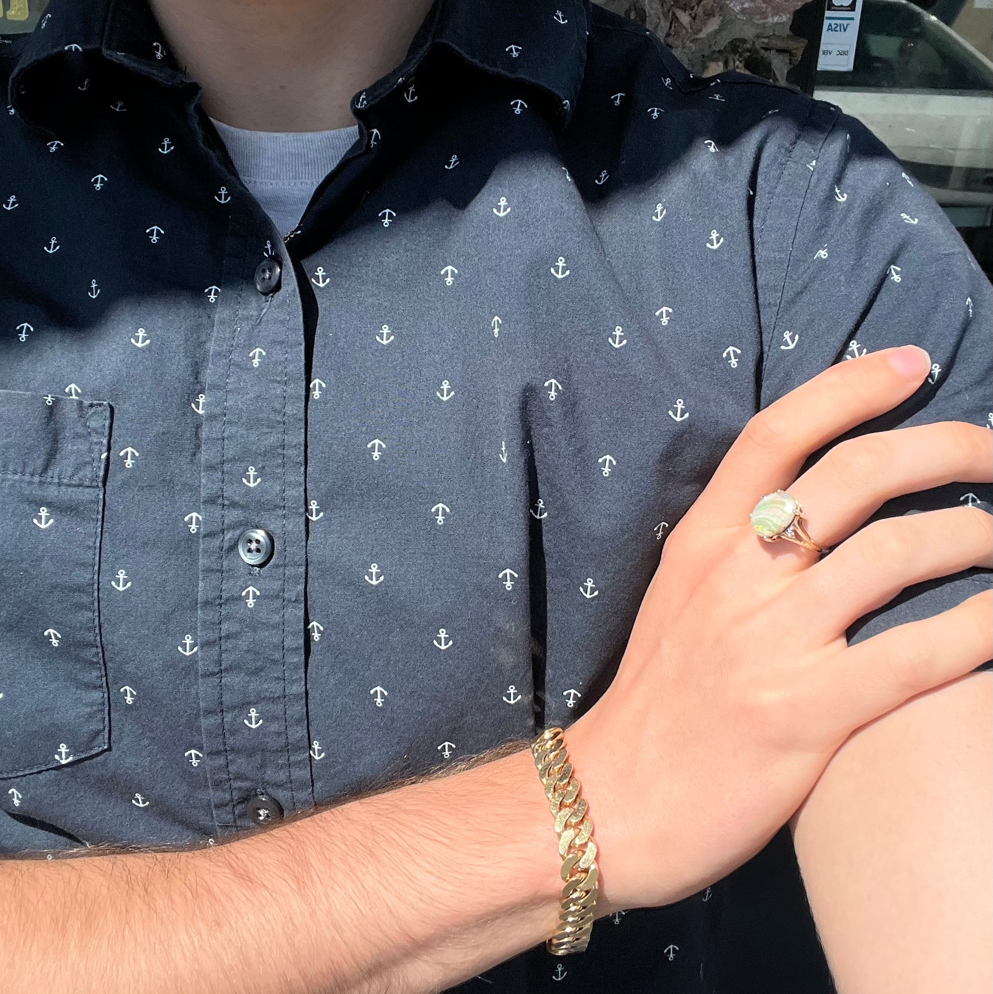 A ladies' Australian boulder opal ring set in yellow gold with diamond accents.  The opal shimmers green and pink and has fissure inclusions.