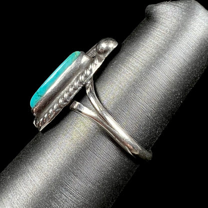 A ladies' sterling silver feather style ring set with a marquise cut turquoise stone.