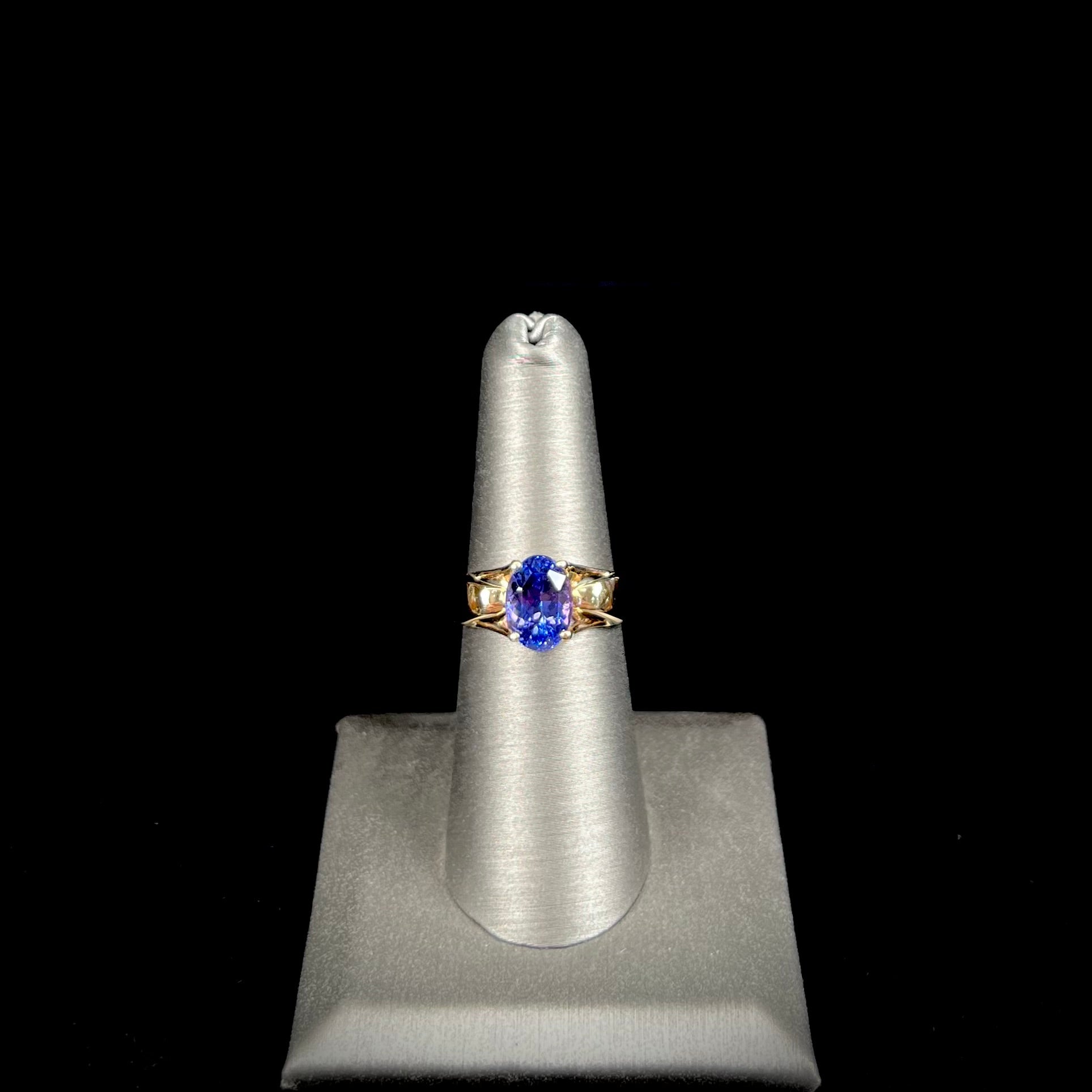 A ladies' oval cut tanzanite solitaire ring set in yellow gold.