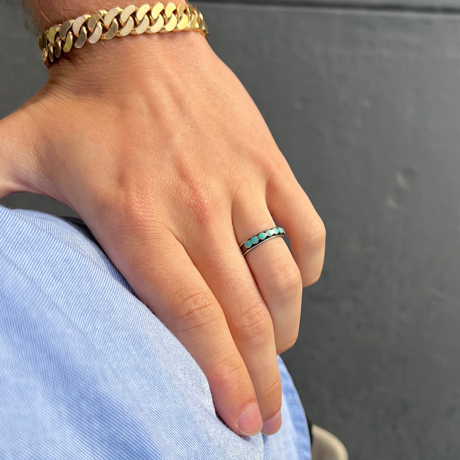 A ladies' sterling silver Hopi style band set with round cut Sleeping Beauty turquoise stones.