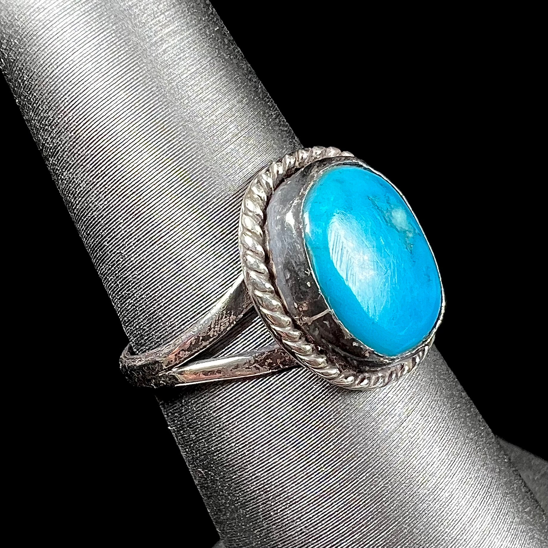 A vintage ladies' Pilot Mountain turquoise ring handmade in sterling silver with a rope accented bezel.