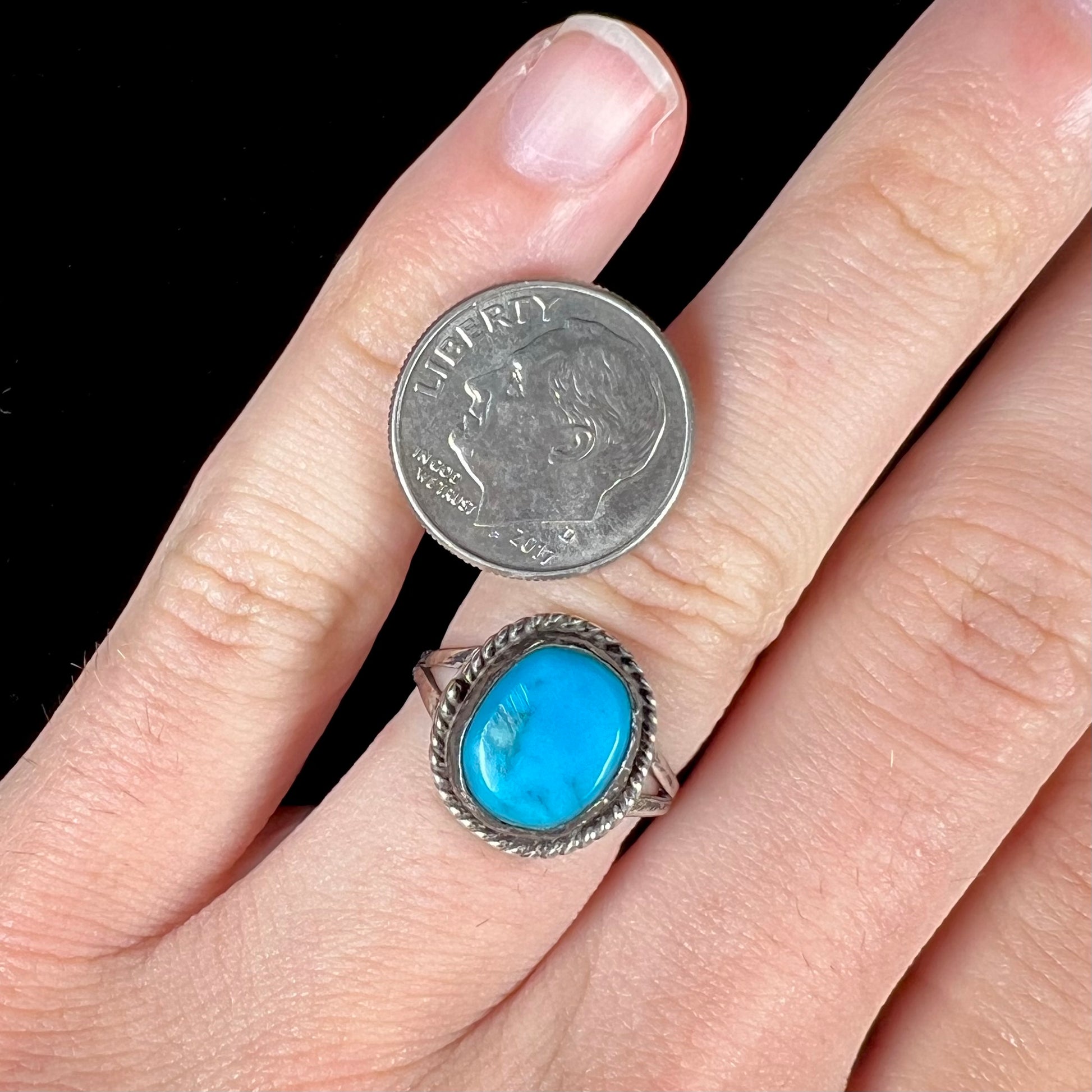 A vintage ladies' Pilot Mountain turquoise ring handmade in sterling silver with a rope accented bezel.
