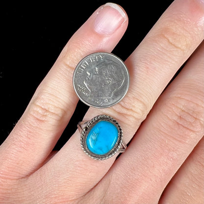 A vintage ladies' Pilot Mountain turquoise ring handmade in sterling silver with a rope accented bezel.