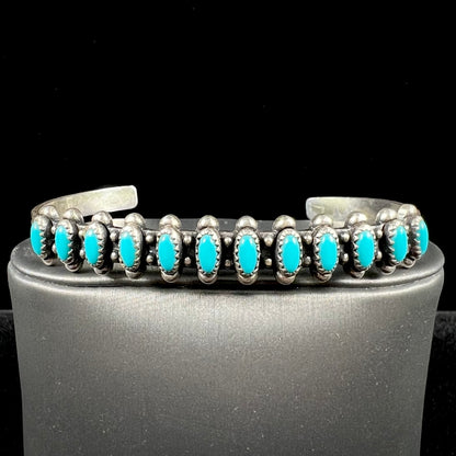 A ladies' sterling silver Zuni Indian turquoise cuff bracelet.  The stones are oval cut Sleeping Beauty turquoise.