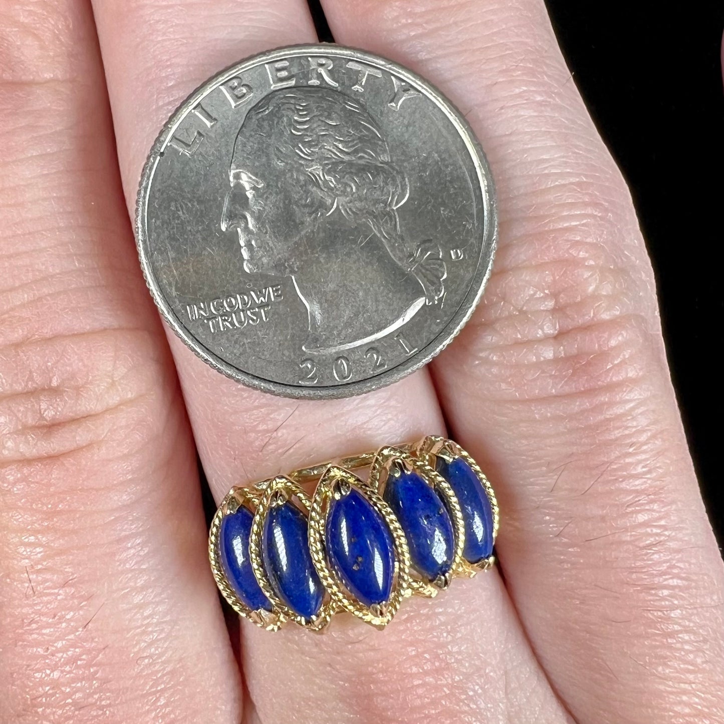 A ladies' five stone marquise cabochon cut lapis lazuli ring in yellow gold.