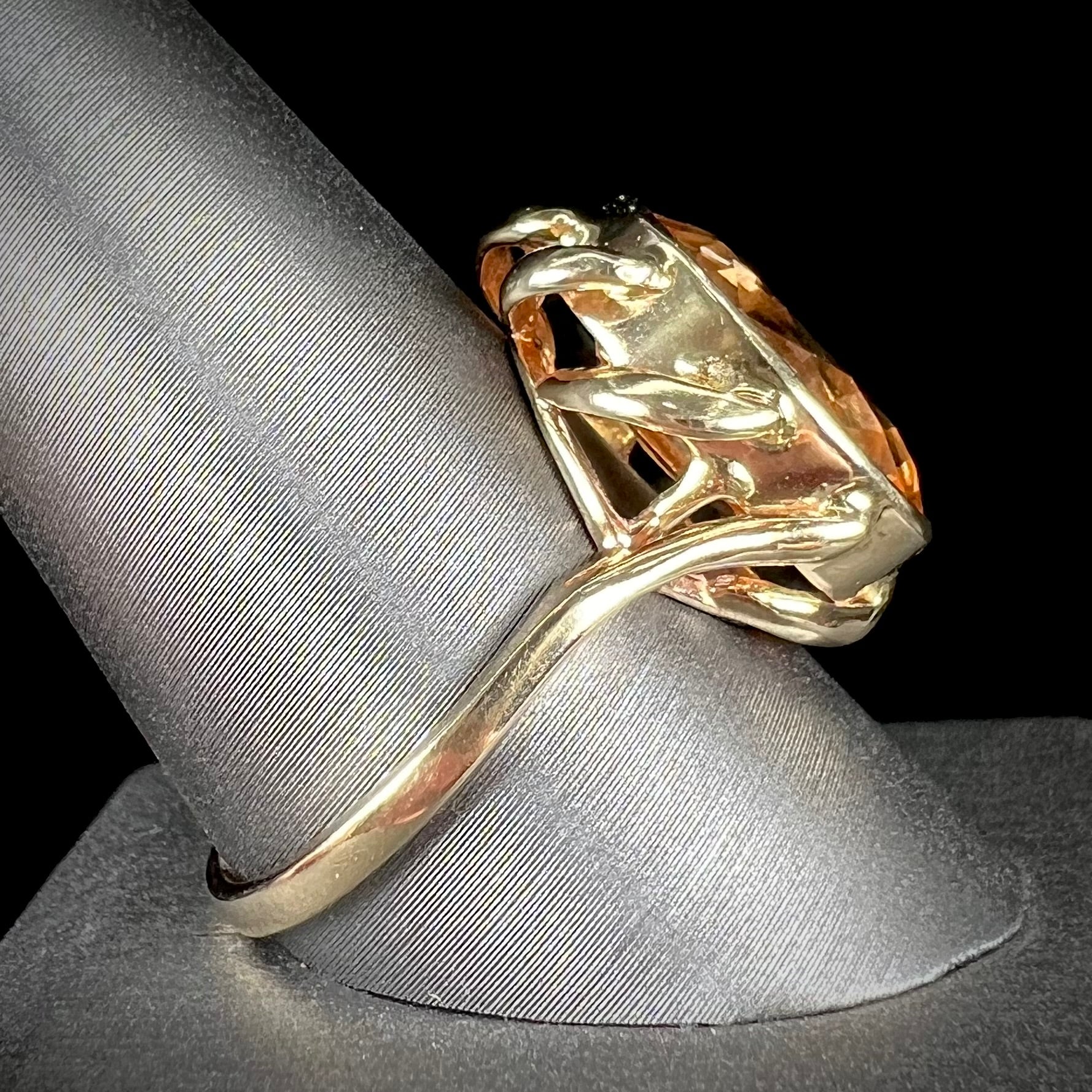 A ladies' yellow gold solitaire ring set with an 8.00 carat oval cut orange hessonite garnet.