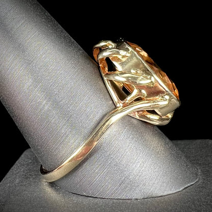 A ladies' yellow gold solitaire ring set with an 8.00 carat oval cut orange hessonite garnet.
