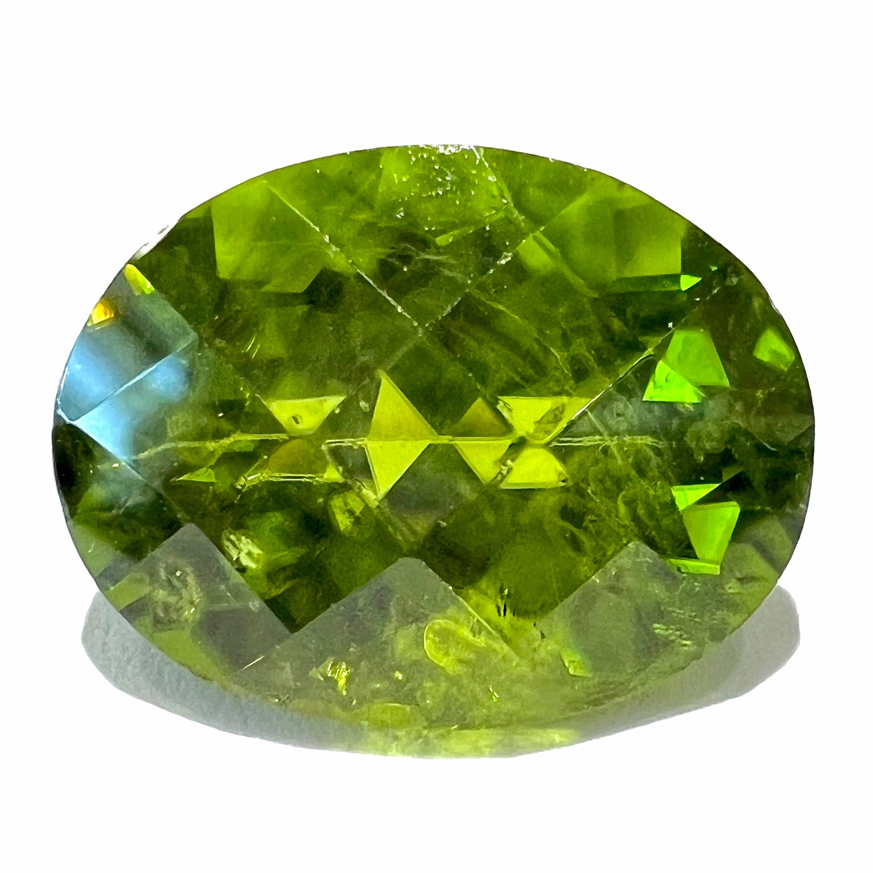 A loose, faceted oval checkerboard cut peridot gemstone from Pakistan.  The stone weighs 17.04 carats.