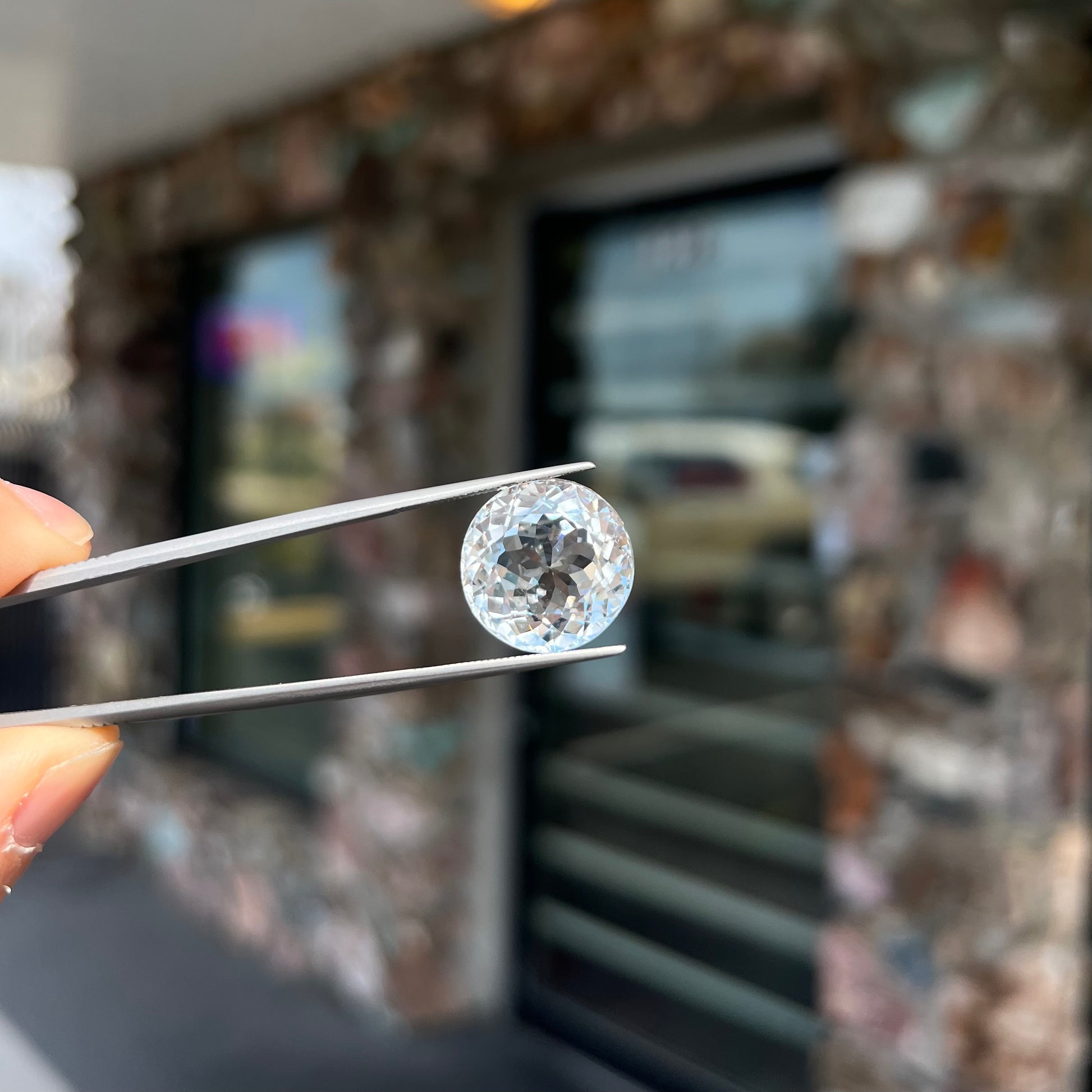 A large, round brilliant cut white topaz gemstone.