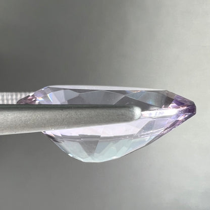 A faceted pear shaped rose de France colored amethyst gemstone.