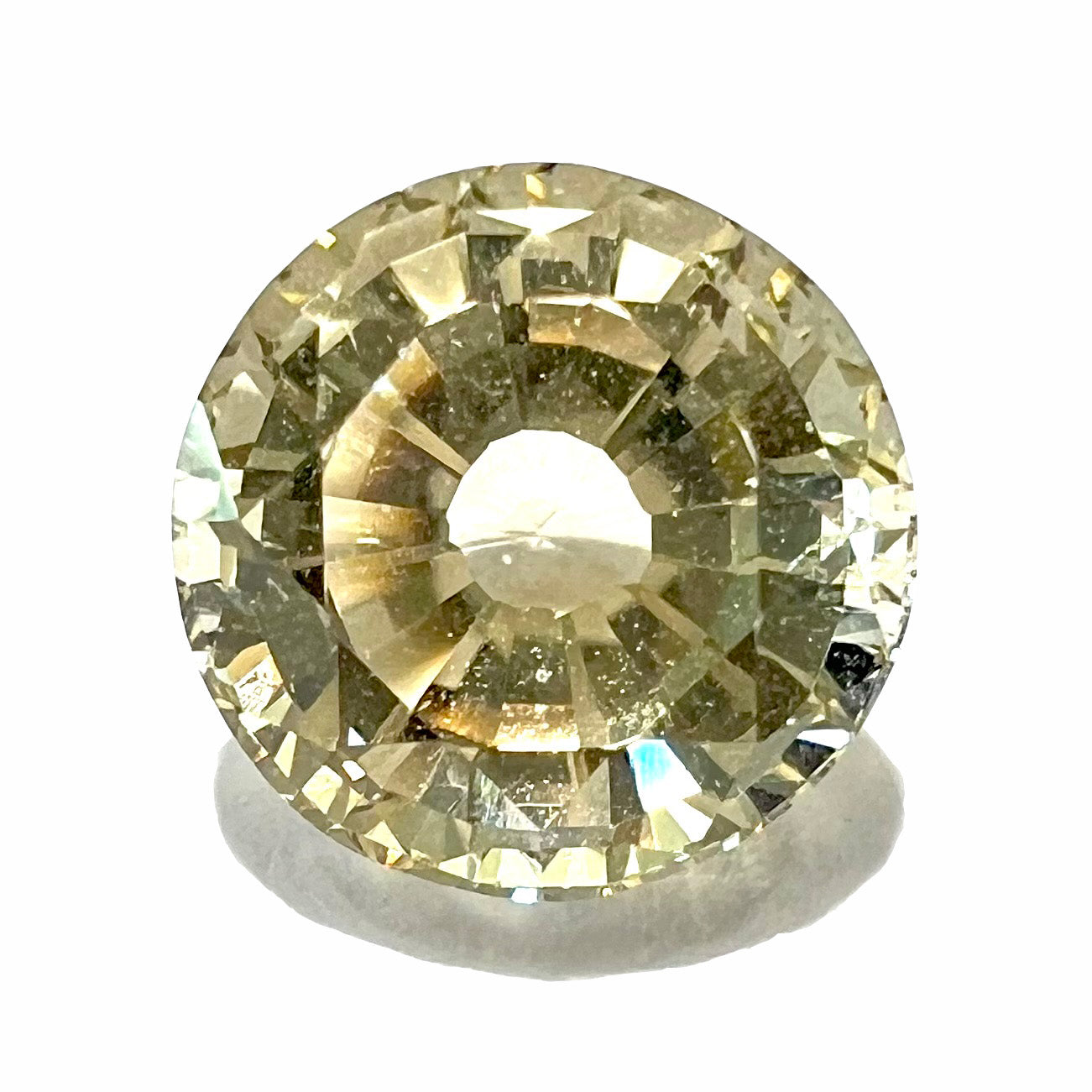 A loose, round brilliant cut citrine gemstone.  The stone is light yellow color and weighs 3.25 carats.