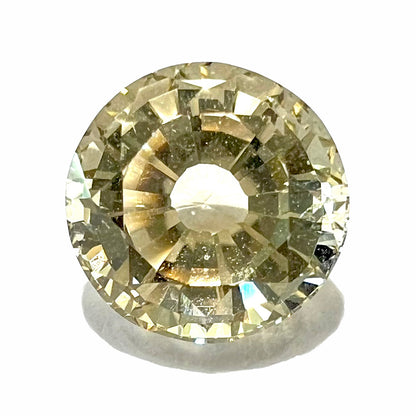 A loose, round brilliant cut citrine gemstone.  The stone is light yellow color and weighs 3.25 carats.