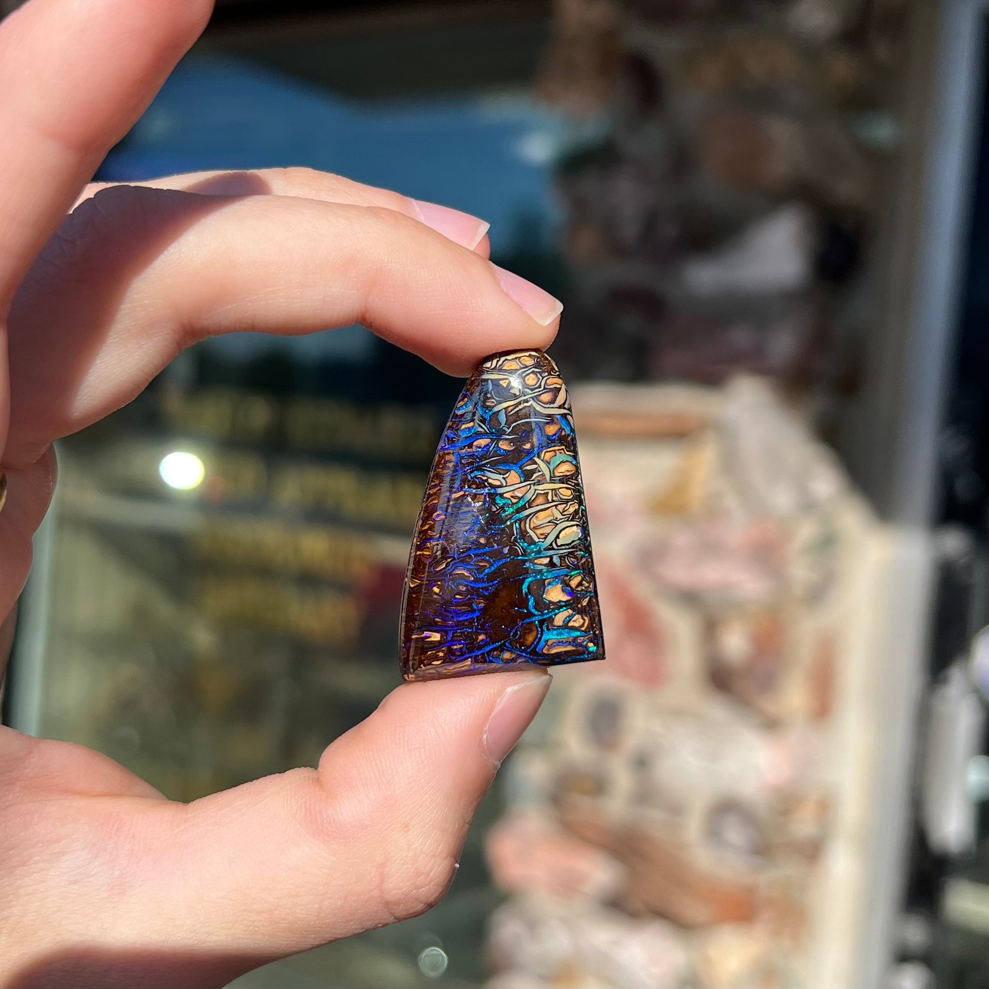 A loose boulder opal stone from Koroit, Australia.  The opal has a blue and purple pattern.