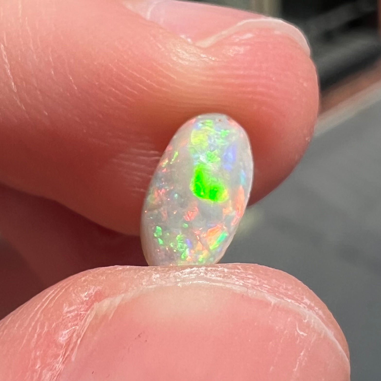 A loose, light opal from Lightning Ridge, Australia.  The opal shines a rainbow of colors.