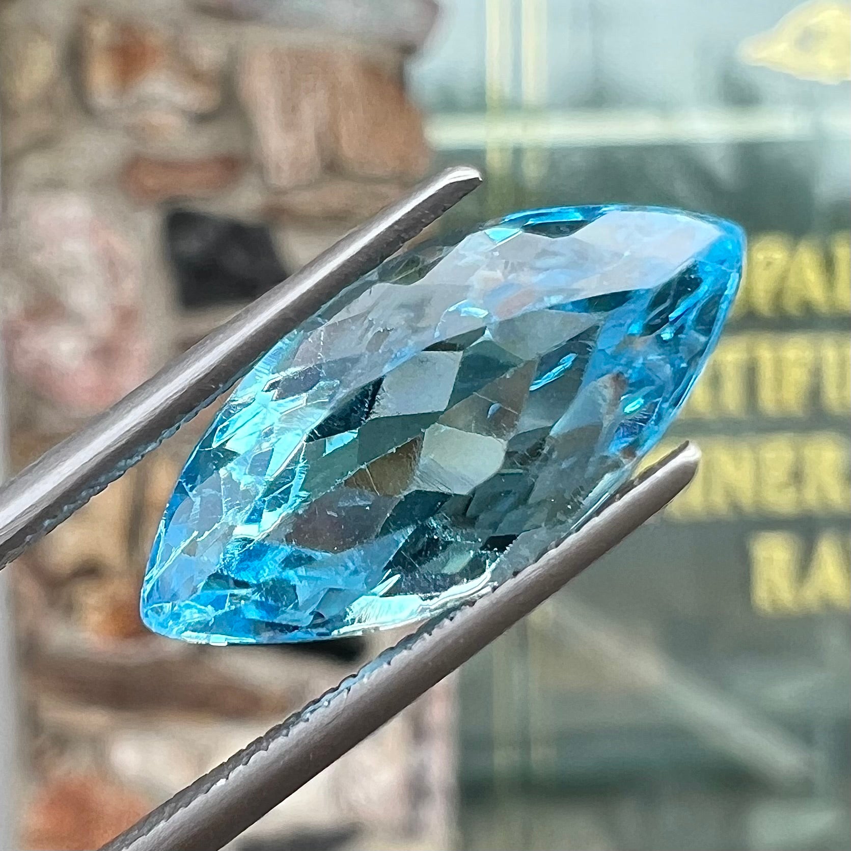 A loose, marquise cut blue topaz gemstone.