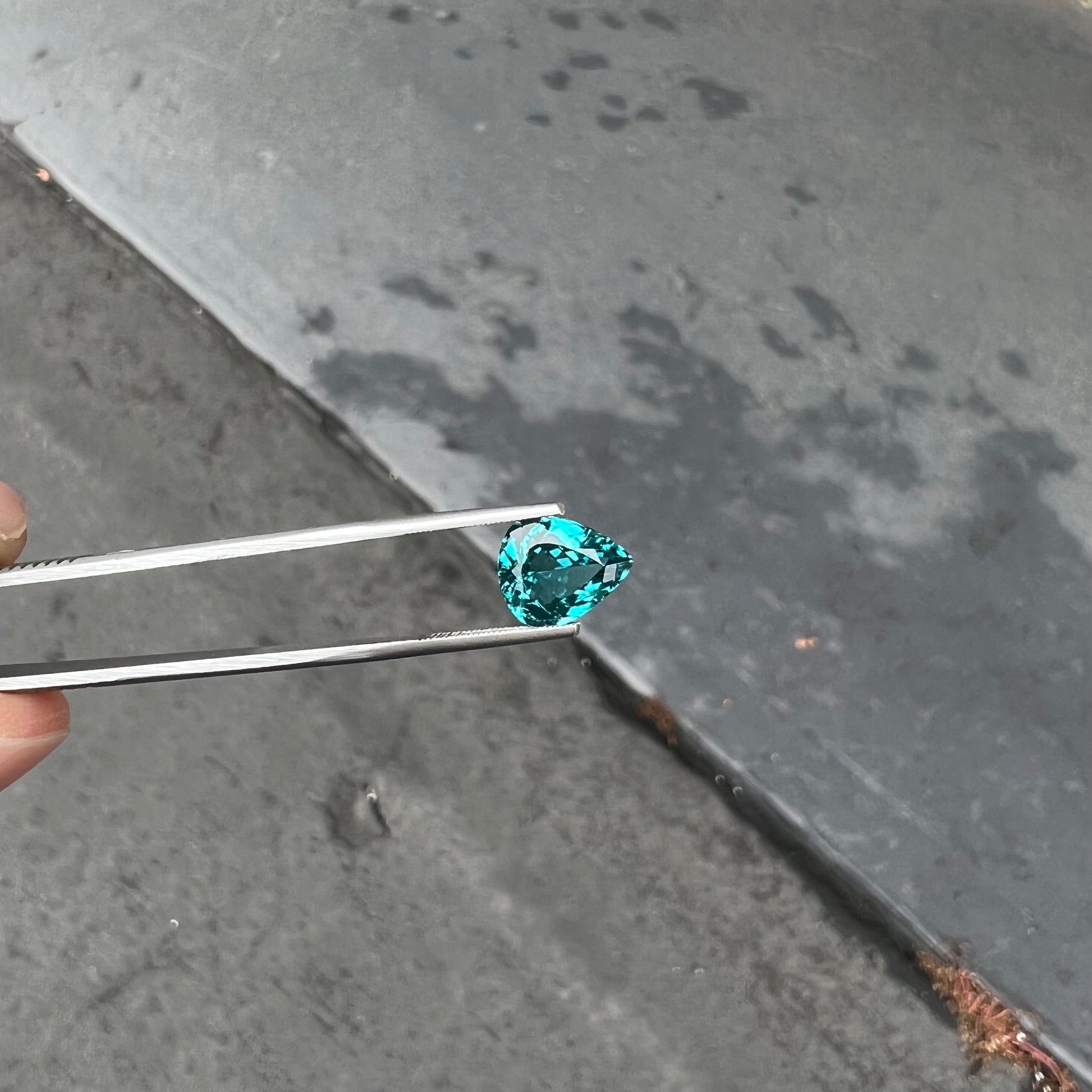 A loose, pear shaped green-blue indicolite tourmaline stone.