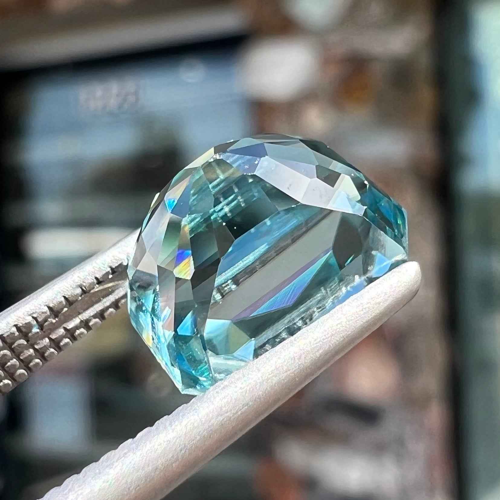 A loose, modified emerald cut blue zircon gemstone.  The stone has a large belly.
