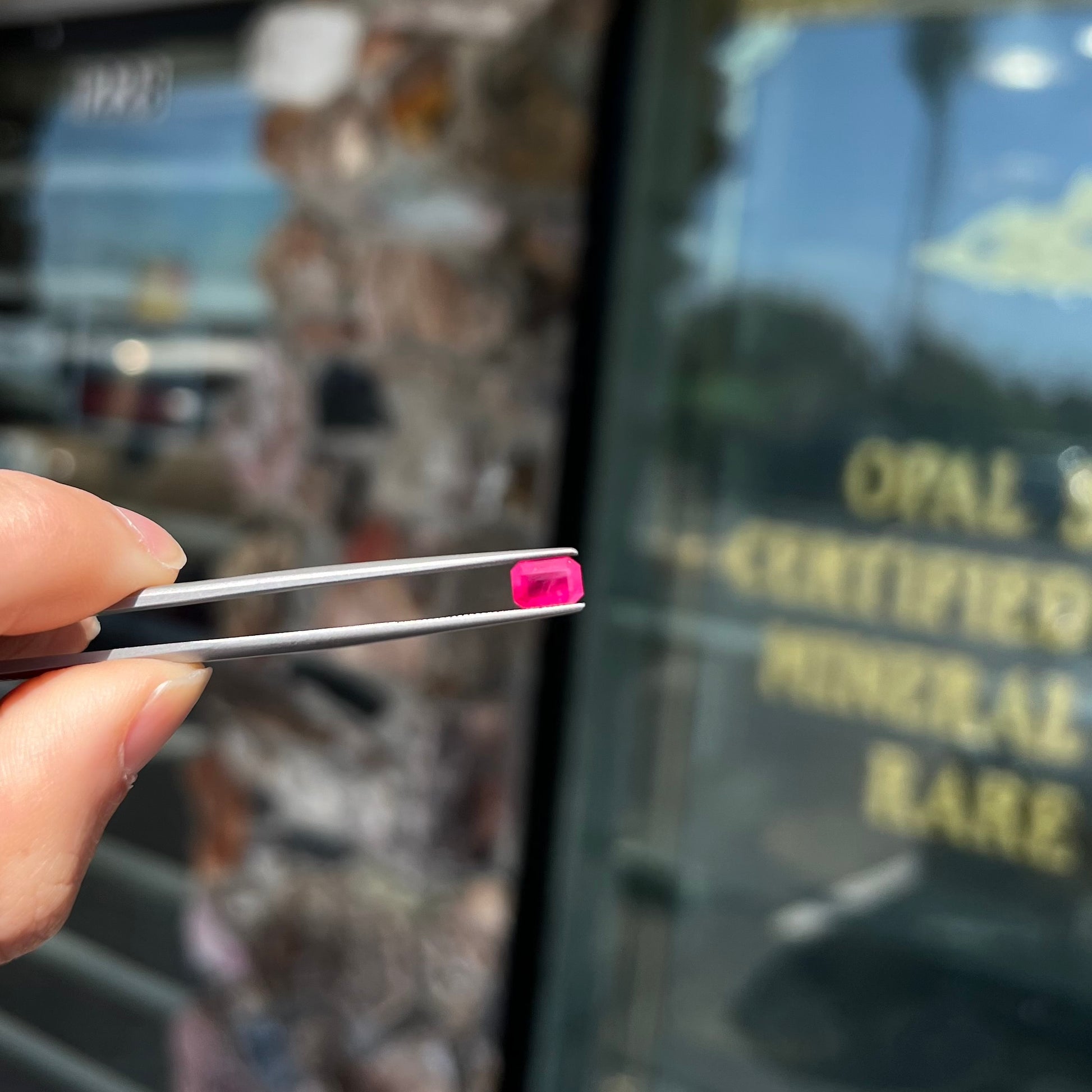 A natural, emerald cut Burma ruby gemstone.  The stone is pinkish red color.