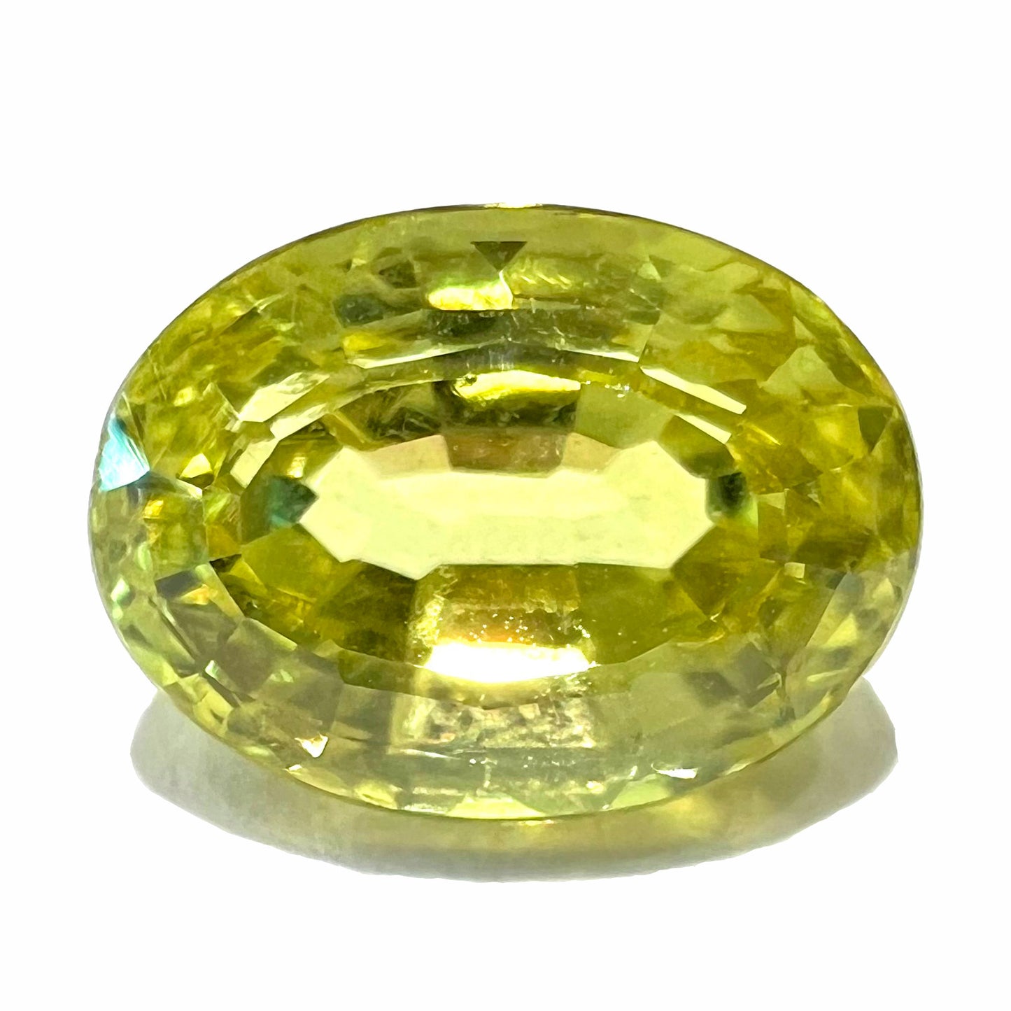 A loose, oval cut greenish yellow chrysoberyl stone.  The chrysoberyl weighs 4.38 carats.